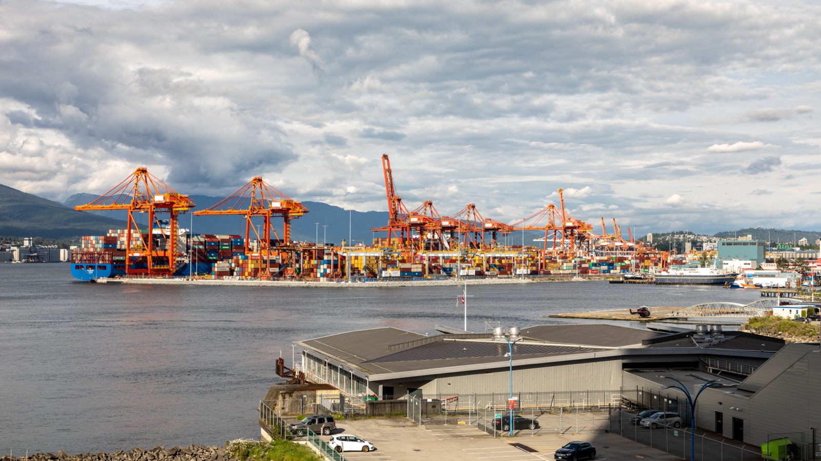 Container ship being unloaded by gantry cranes at the Port of Vancouver, Canada
