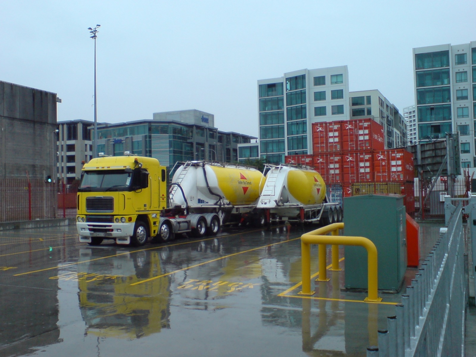 Bulk cement carrier discharging clinker at a port silo terminal
