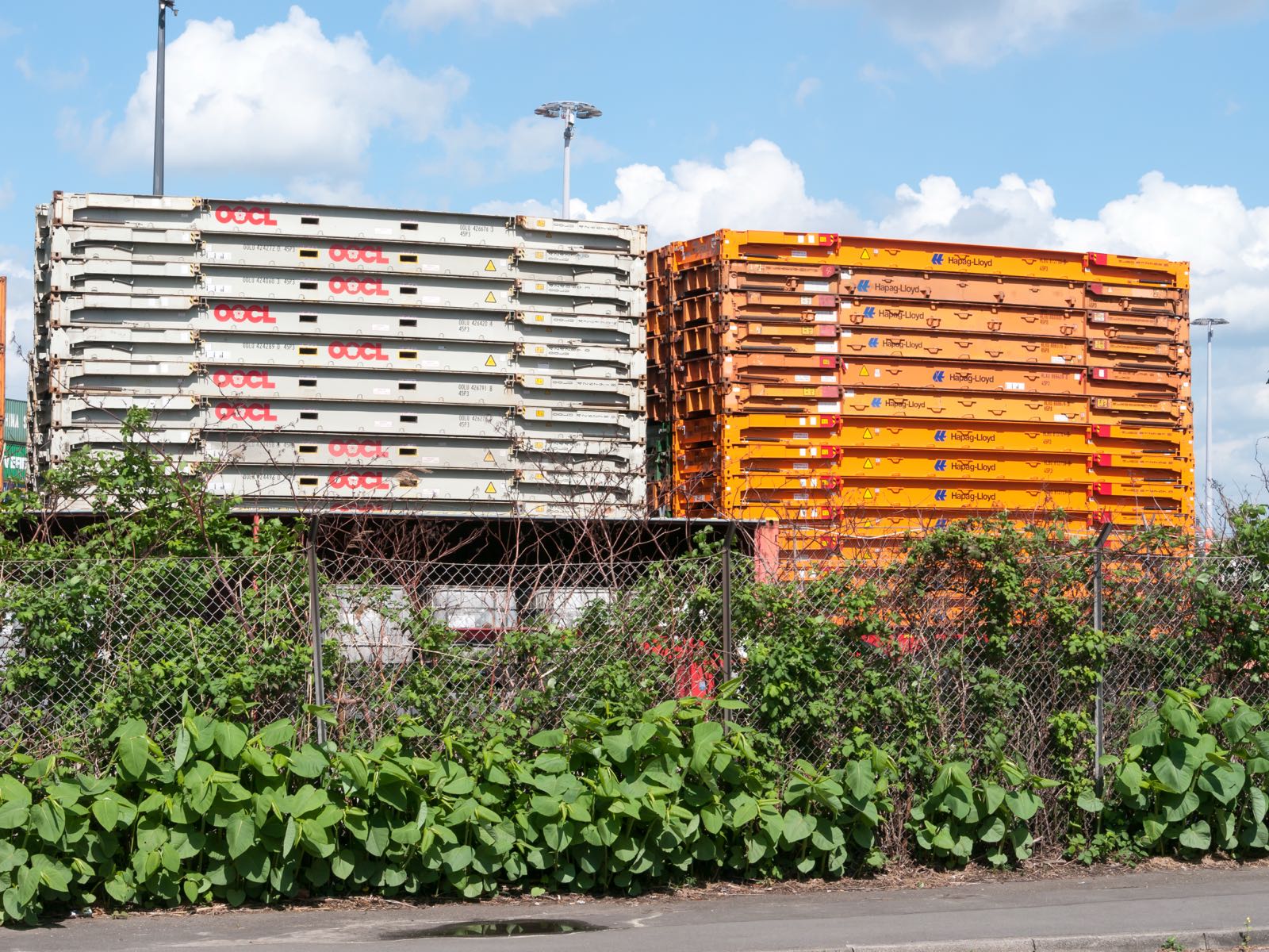 Full container load sealed at origin beside less-than-container-load cargo being consolidated at a freight station