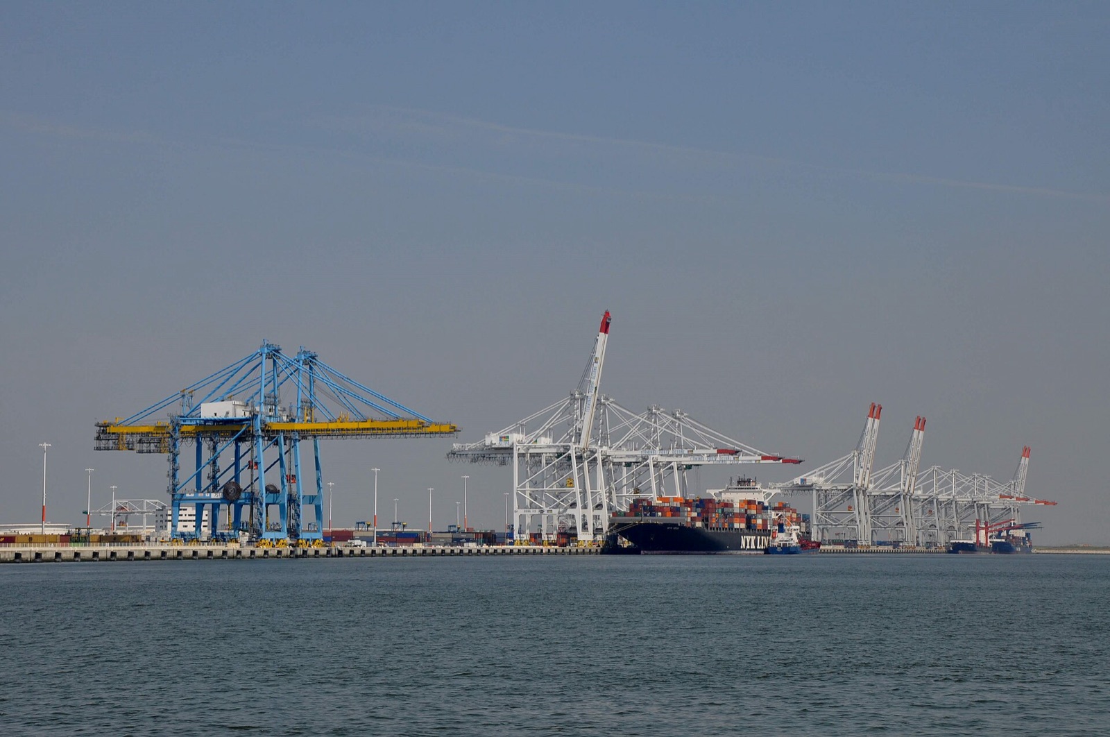 Container ship berthed at the Port of Le Havre with gantry cranes loading containers, France