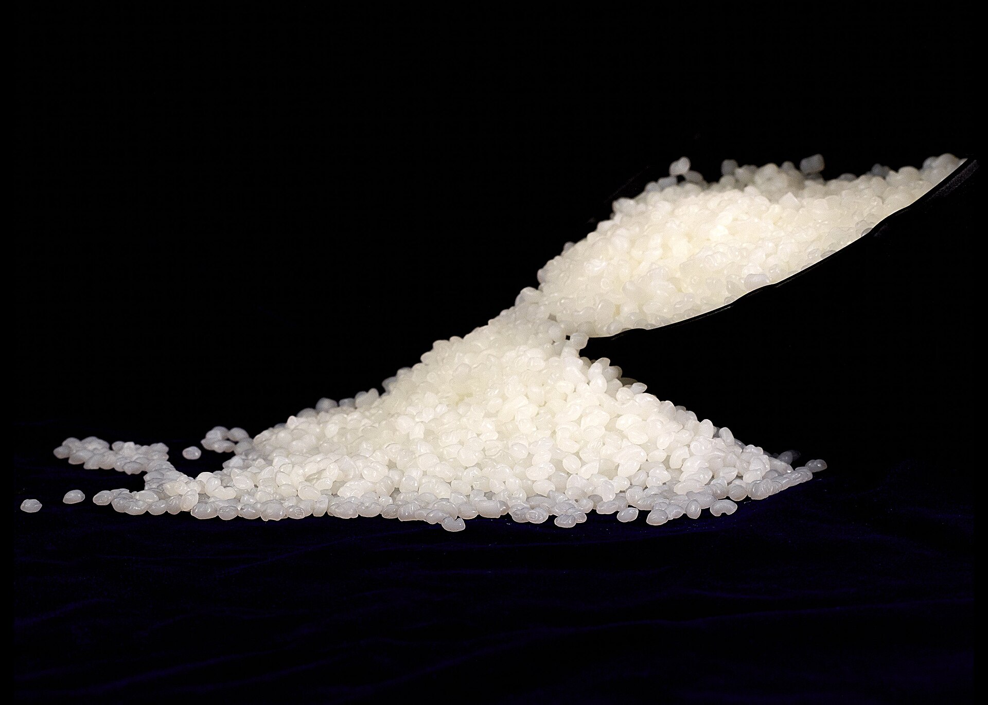 Plastic polymer granules being loaded into bulk bags at a processing plant