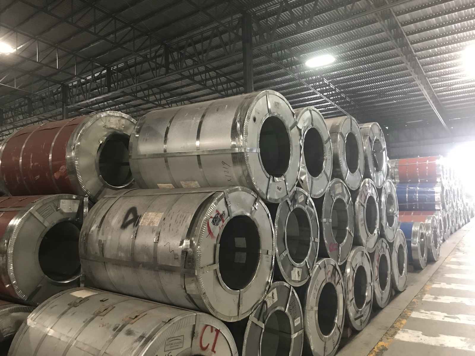 Coils of hot-rolled steel stacked at an Indian port ready for export